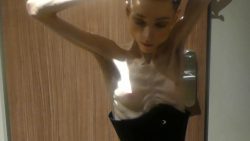 Christin posing435345454 naked and wearing a corset indoors 00002